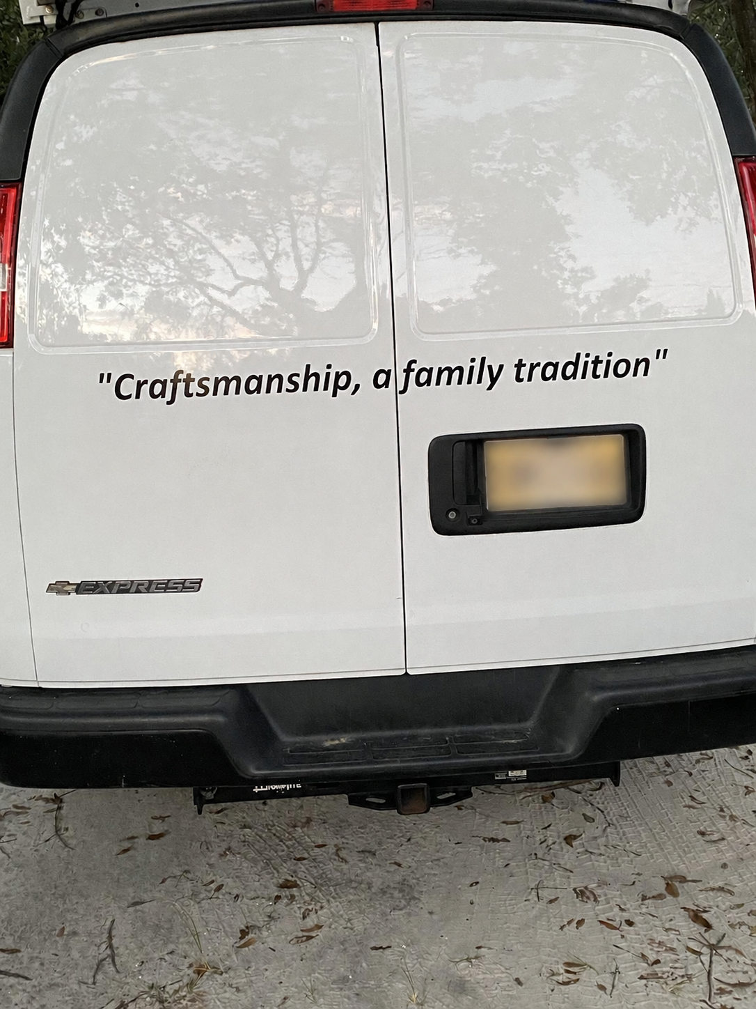 Rear of Nolan Flowers Painting work van with family tradition slogan